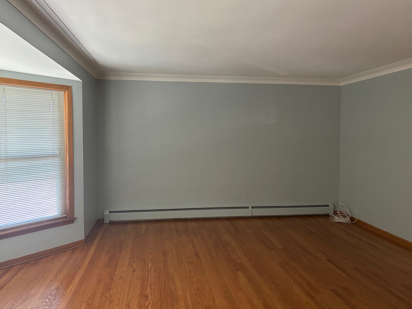 6401 West 52nd Street, Unit 2 Chicago, IL 60638 - Photo 13 of 16 a view of an empty room with wooden floor and a window