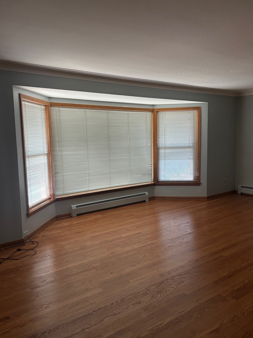6401 West 52nd Street, Unit 2 Chicago, IL 60638 - Photo 14 of 16 an empty room with wooden floor and windows