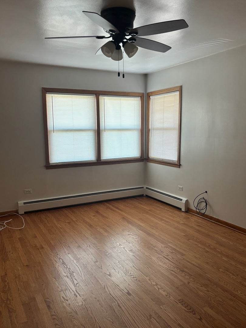 6401 West 52nd Street, Unit 2 Chicago, IL 60638 - Photo 16 of 16 an empty room with wooden floor and windows