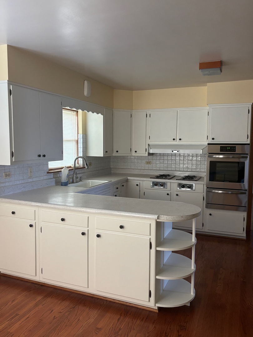 6401 West 52nd Street, Unit 2 Chicago, IL 60638 - Photo 4 of 16 a kitchen with granite countertop white cabinets and white appliances