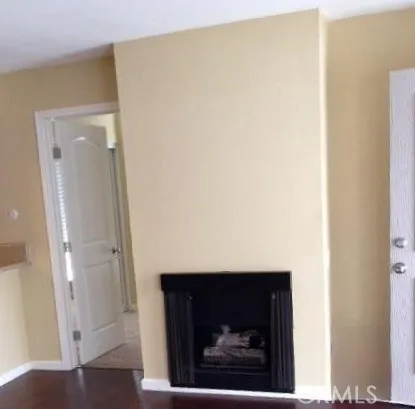 a living room with a wooden floor and a fireplace