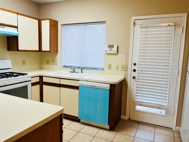 a kitchen with a sink cabinets and appliances