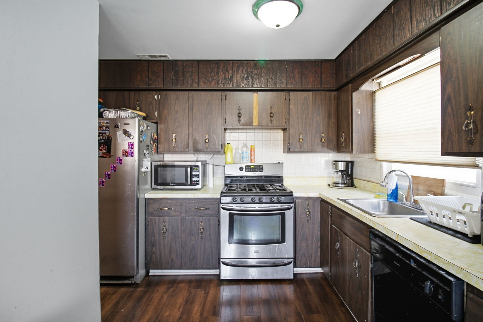 6611 West 83rd Street Burbank, IL 60459 - Photo 11 of 29 a kitchen with stainless steel appliances granite countertop a stove a sink dishwasher a refrigerator and a microwave
