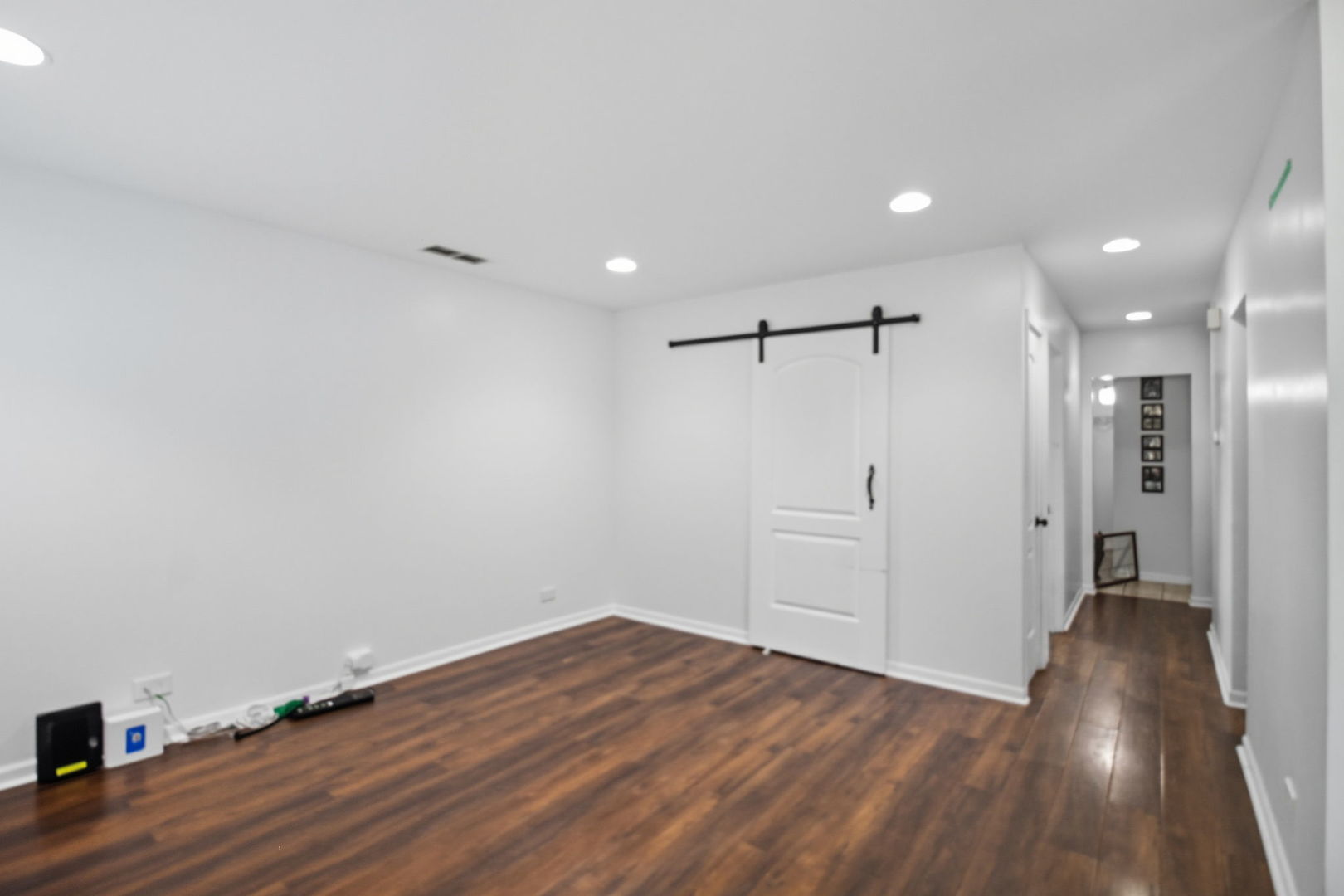 6611 West 83rd Street Burbank, IL 60459 - Photo 4 of 29 a view of a room with wooden floors and white walls
