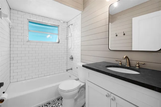 a view of an empty room with a window and a fireplace