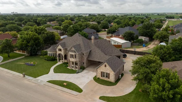 an aerial view of a house with garden space and street view