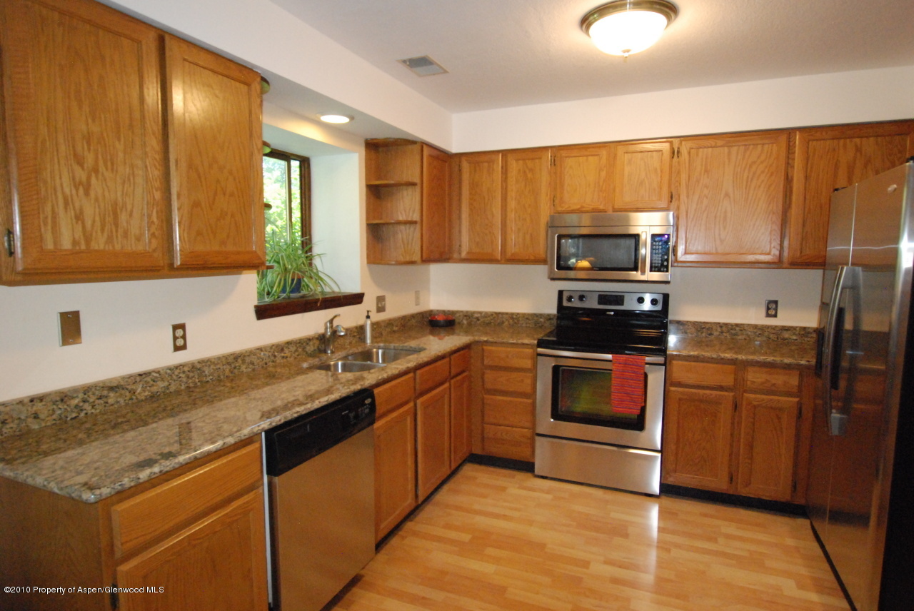 40 B Riversedge Court Basalt, CO 81621 - Photo 7 of 11 a kitchen with stainless steel appliances granite countertop a sink stove and refrigerator
