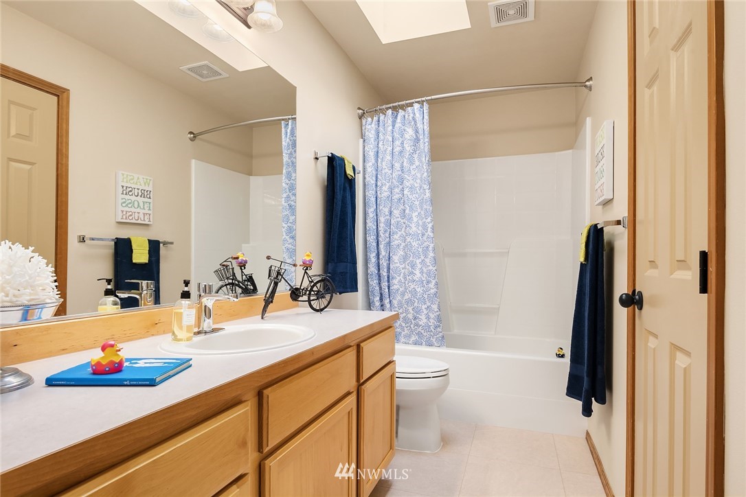 210 Hubbard Road, Unit 2 Lynnwood, WA 98036 - Photo 18 of 25 a bathroom with a double vanity sink toilet and shower