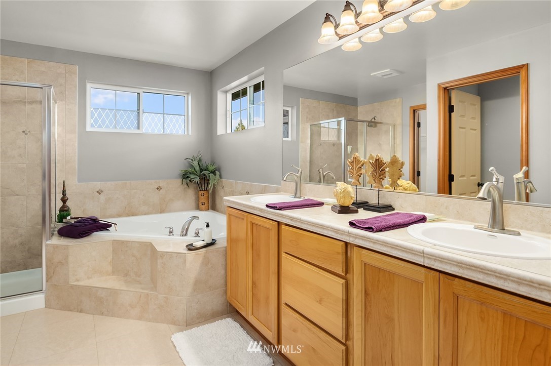 210 Hubbard Road, Unit 2 Lynnwood, WA 98036 - Photo 21 of 25 a bath room with a sink vanity tub and a mirror