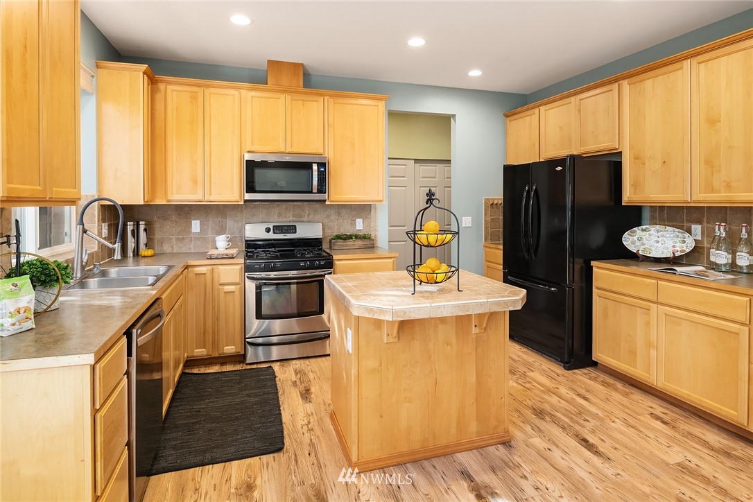 210 Hubbard Road, Unit 2 Lynnwood, WA 98036 - Photo 7 of 25 a kitchen with stainless steel appliances granite countertop a refrigerator a stove top oven a sink and dishwasher