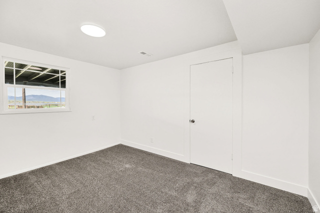 4155 Johnson Road Nibley, UT 84321 - Photo 42 of 71 Empty room with baseboards and dark colored carpet