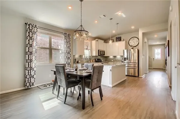 a kitchen with cabinets and wooden floor