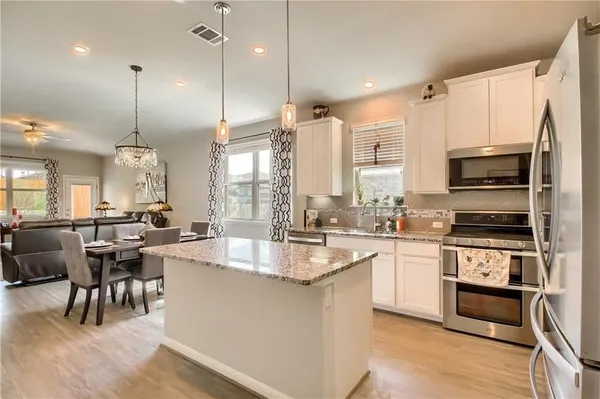 a large kitchen with kitchen island a large island in the center