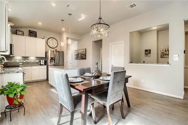 a view of a dining room with furniture and wooden floor