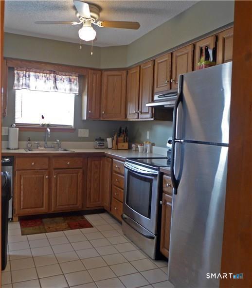 11 MacIntosh Lane, Unit 11 Ansonia, CT 06401 - Photo 2 of 13 a kitchen with stainless steel appliances granite countertop a refrigerator sink and cabinets