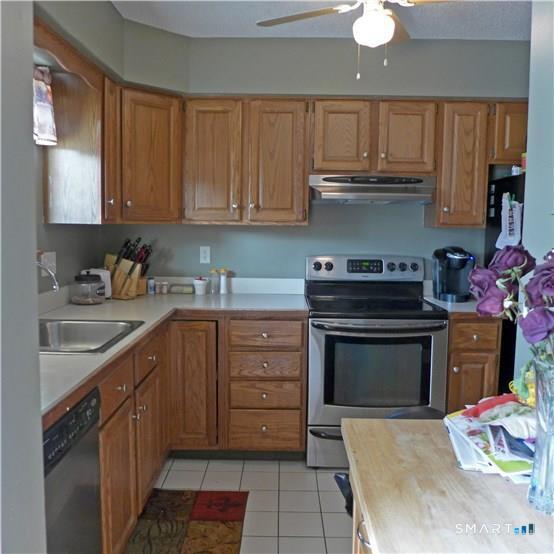 11 MacIntosh Lane, Unit 11 Ansonia, CT 06401 - Photo 3 of 13 a kitchen with granite countertop a stove sink and cabinets