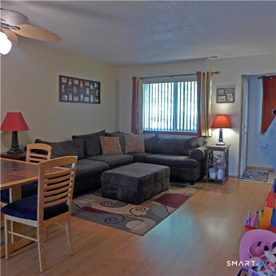 11 MacIntosh Lane, Unit 11 Ansonia, CT 06401 - Photo 5 of 13 a living room with furniture a lamp and a window
