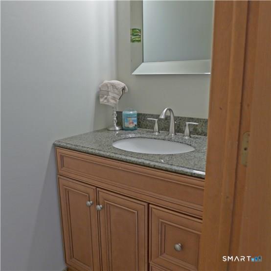 11 MacIntosh Lane, Unit 11 Ansonia, CT 06401 - Photo 7 of 13 a bathroom with a sink and vanity