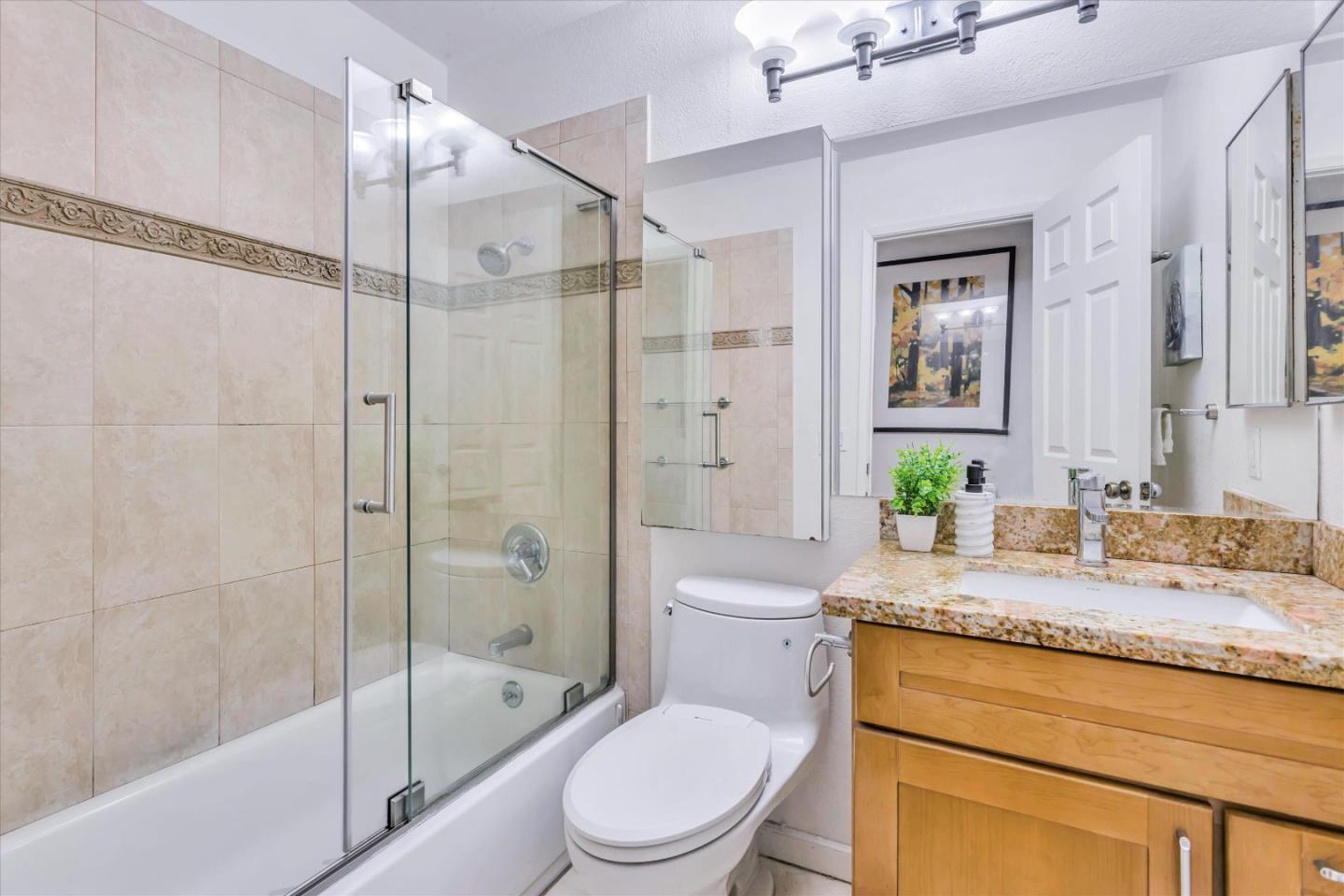 499 Bayview Park Drive Milpitas, CA 95035 - Photo 21 of 41 a bathroom with a granite countertop toilet sink and shower
