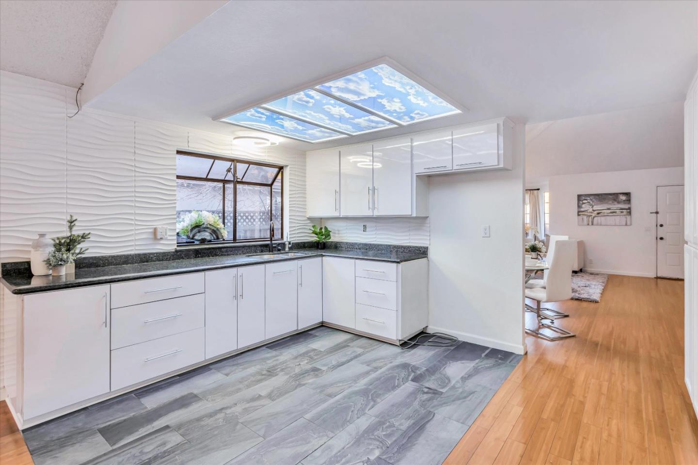 499 Bayview Park Drive Milpitas, CA 95035 - Photo 8 of 41 a kitchen with a sink window and cabinets