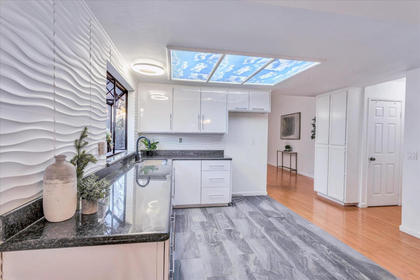499 Bayview Park Drive Milpitas, CA 95035 - Photo 9 of 41 a kitchen with stainless steel appliances granite countertop a white cabinets and wooden floor