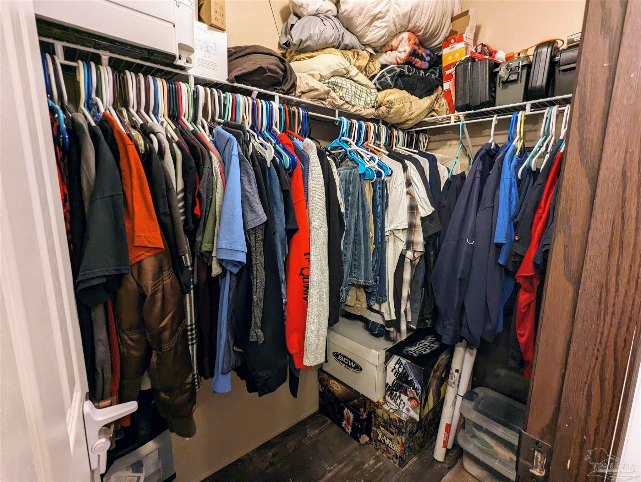 6261 Morgan Road Milton, FL 32570 - Photo 14 of 19 a view of walk in closet with clothes and shoes