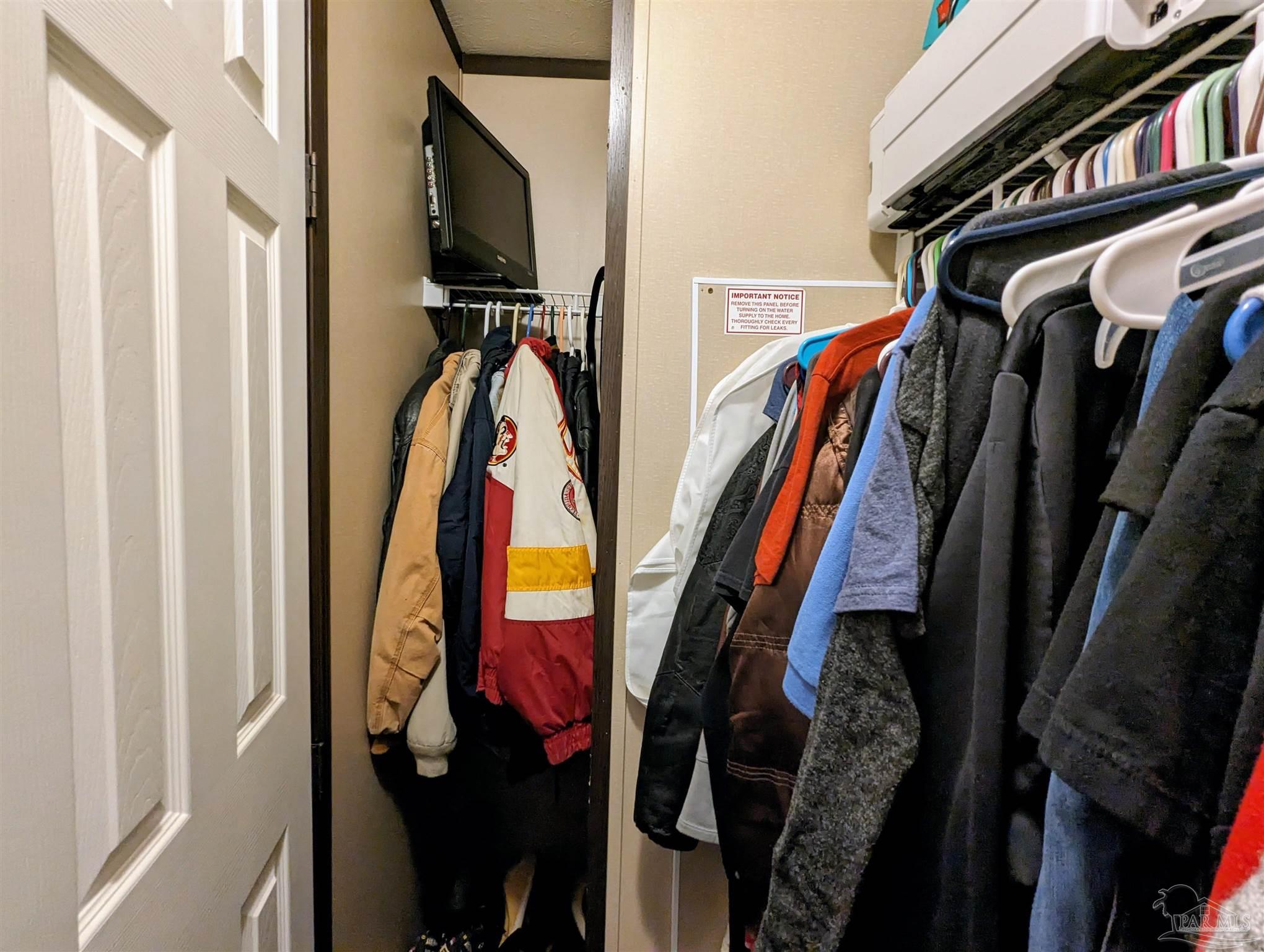 6261 Morgan Road Milton, FL 32570 - Photo 15 of 19 a view of walk in closet with clothes and shoes