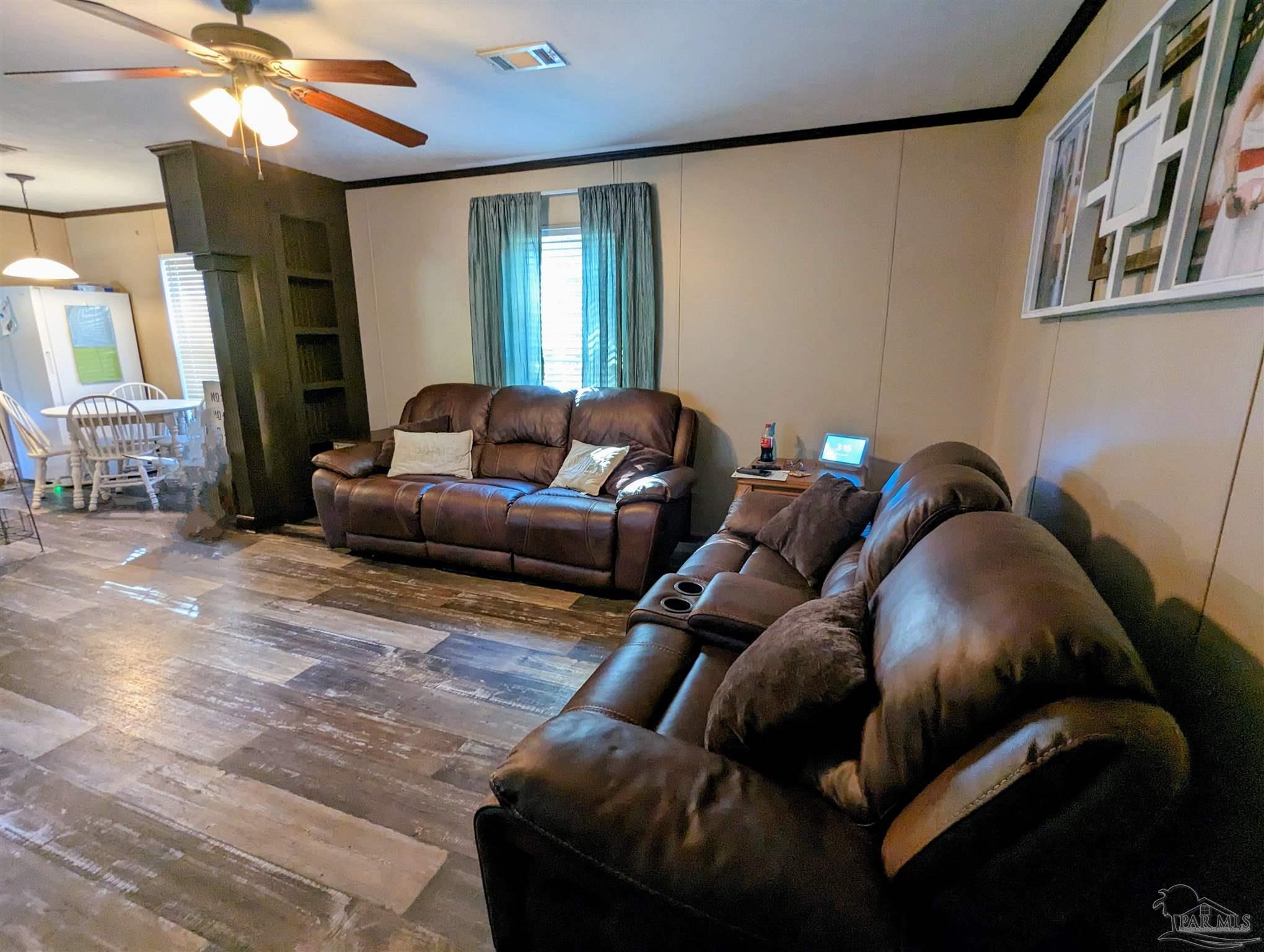 6261 Morgan Road Milton, FL 32570 - Photo 5 of 19 a living room with furniture and a mirror