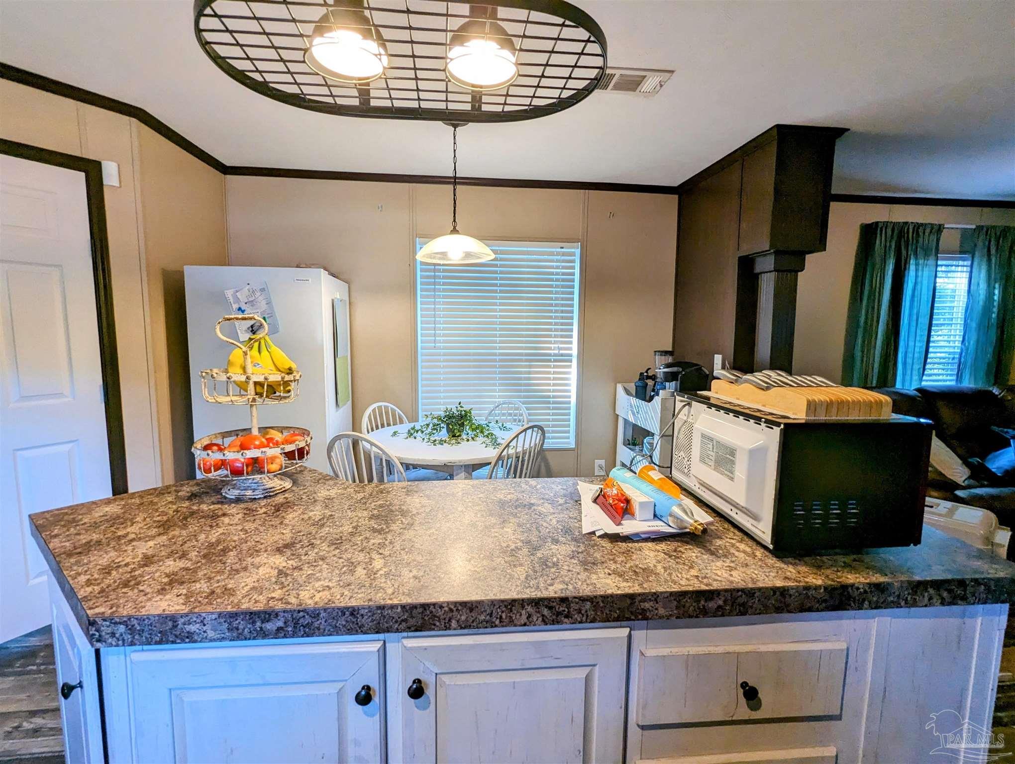 6261 Morgan Road Milton, FL 32570 - Photo 8 of 19 a living room with granite countertop kitchen island a table and chairs