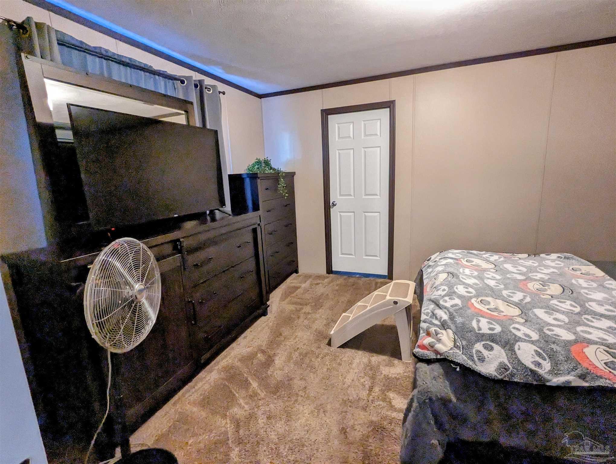 6261 Morgan Road Milton, FL 32570 - Photo 10 of 19 a bedroom with a bed and furniture