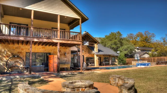 a view of a backyard with swimming pool