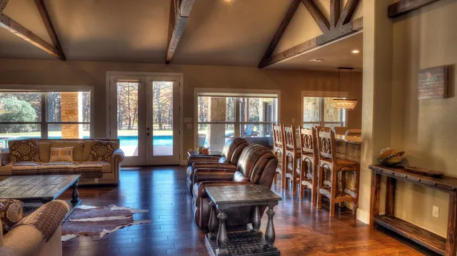 a kitchen with stainless steel appliances granite countertop a sink a refrigerator and wooden cabinets