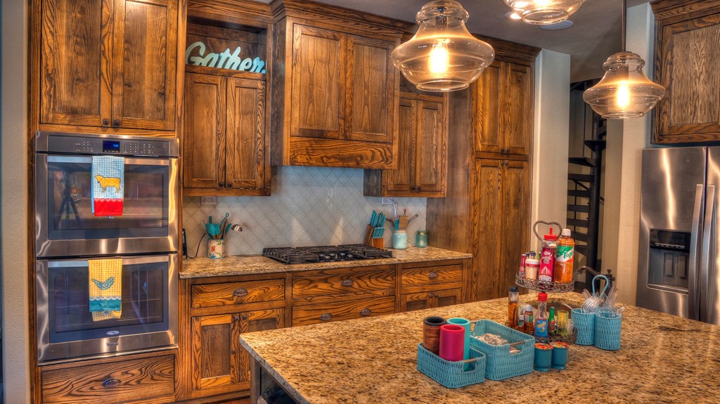 6454 Highway 83 Leakey, TX 78873 - Photo 32 of 74 a kitchen with stainless steel appliances granite countertop a stove and cabinets