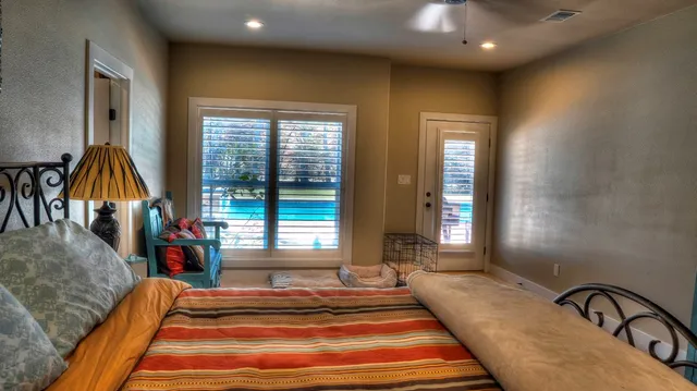 a living room with furniture a flat screen tv and a large window