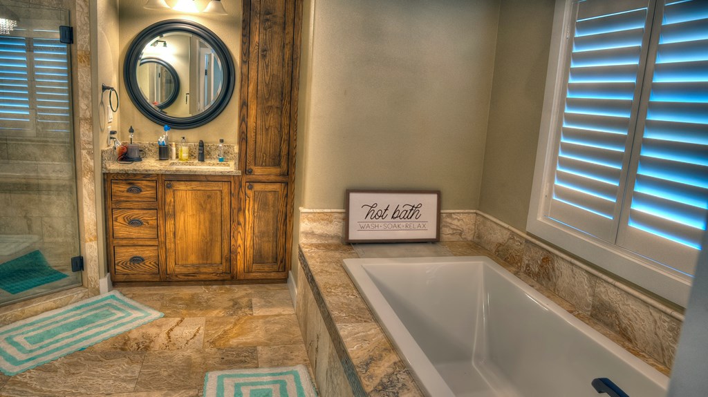 6454 Highway 83 Leakey, TX 78873 - Photo 38 of 74 a bathroom with a sink a mirror and a bathtub