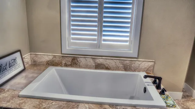 a kitchen with a sink stove top oven and cabinets