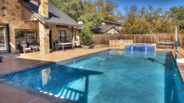 a view of a house with swimming pool and sitting area