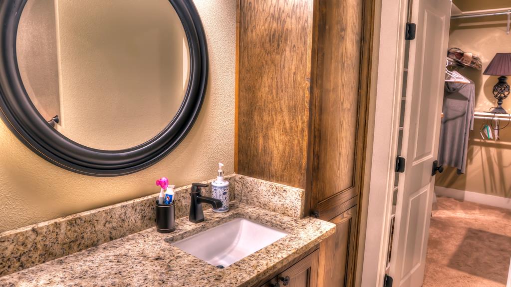 6454 Highway 83 Leakey, TX 78873 - Photo 41 of 74 a bathroom with a granite countertop sink and a mirror