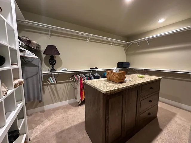 a bedroom with a bed and a mirror on dresser