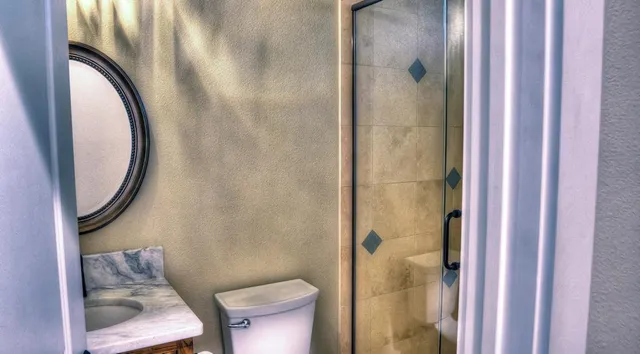 a bathroom with a toilet and a shower