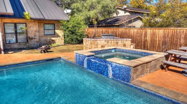 a view of a house with swimming pool patio and a yard