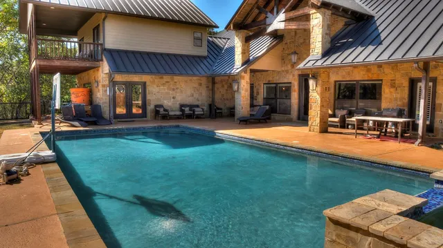 a view of swimming pool with lounge chair and couch