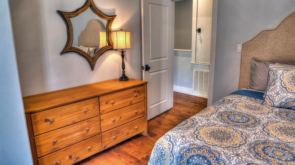 6454 Highway 83 Leakey, TX 78873 - Photo 63 of 74 a bedroom with a bed and a mirror on dresser