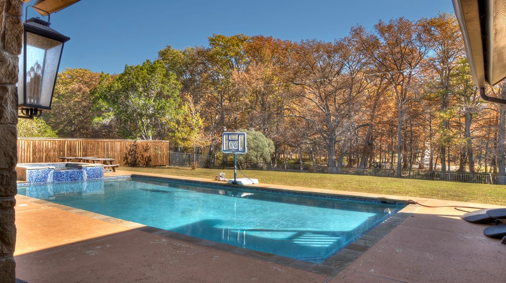 6454 Highway 83 Leakey, TX 78873 - Photo 10 of 74 a view of a swimming pool with an outdoor space and seating area