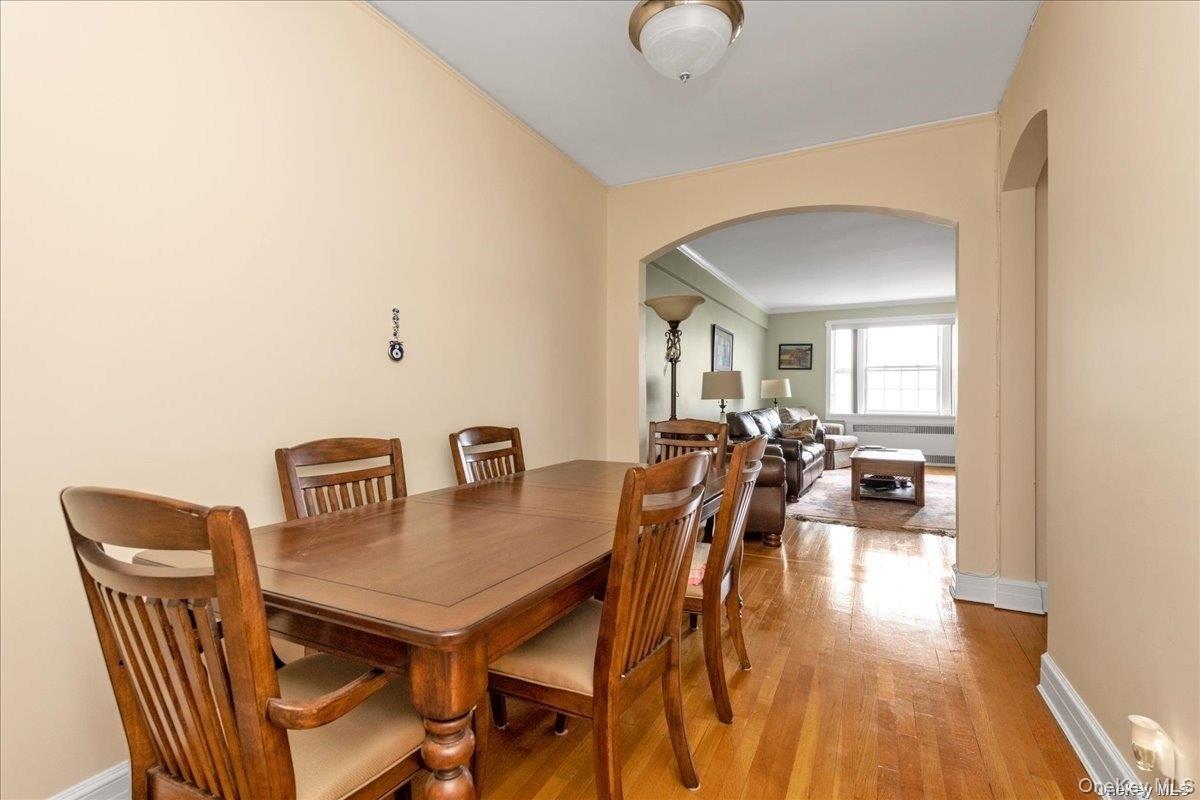 175-06 Devonshire Road, Unit 6O Queens, NY 11432 - Photo 5 of 14 a view of a dining room with furniture and wooden floor