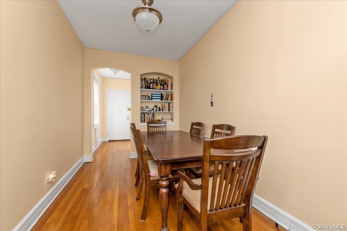 175-06 Devonshire Road, Unit 6O Queens, NY 11432 - Photo 6 of 14 a view of a dining room with furniture and wooden floor
