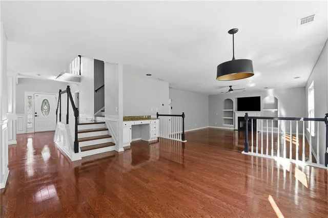 a view of entryway and hall with wooden floor