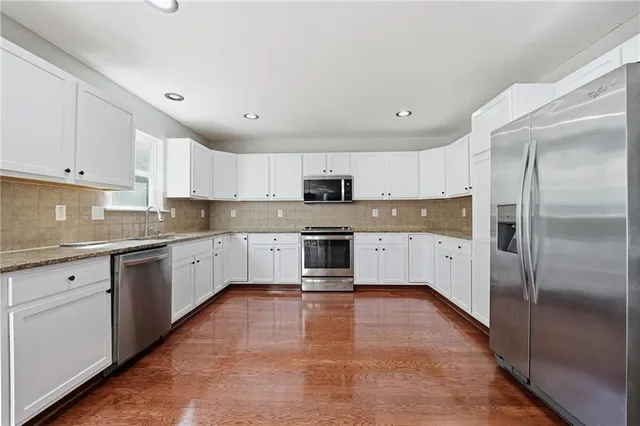 a view of a livingroom with a fireplace a microwave and a window