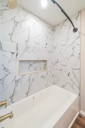 a bathroom with a bathtub and shower
