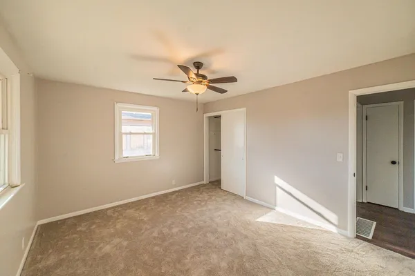a view of a livingroom with a ceiling fan and window